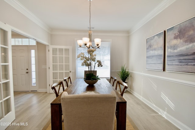 218 Country Club Dr SW, Shallotte, NC 28470 - dining room with crown molding, an inviting chandelier, plenty of natural light, and light wood-type flooring