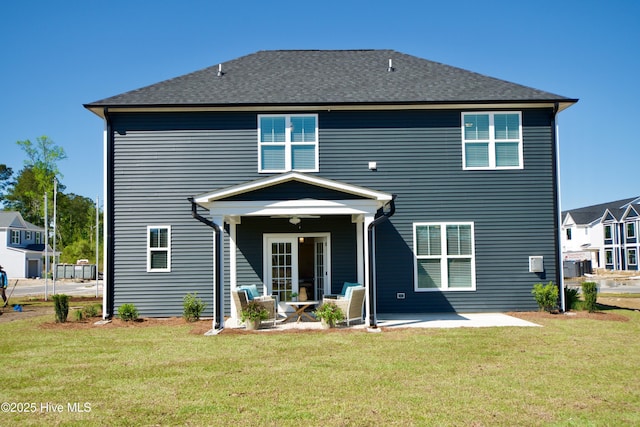 218 Country Club Dr SW, Shallotte, NC 28470 - back of property featuring a patio, a shingled roof, and a lawn