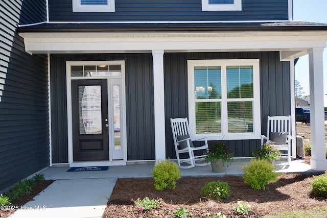 218 Country Club Dr SW, Shallotte, NC 28470 - property entrance featuring covered porch and board and batten siding