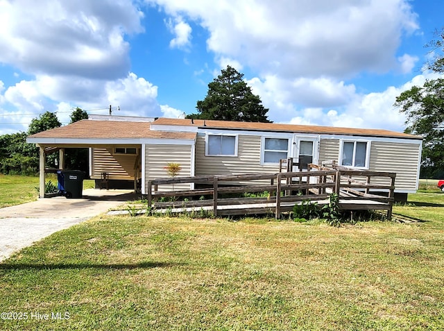 view of front of property featuring a front lawn, a wooden deck, and concrete driveway