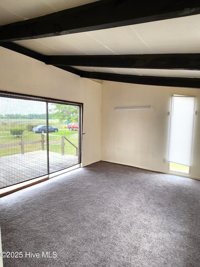 carpeted empty room with beam ceiling