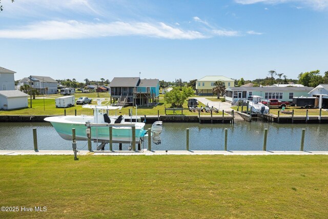 dock with a residential view, boat lift, and a water view