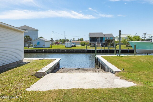 dock area featuring a water view, a lawn, and a residential view