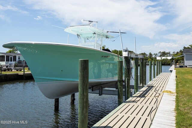 dock area with boat lift and a water view