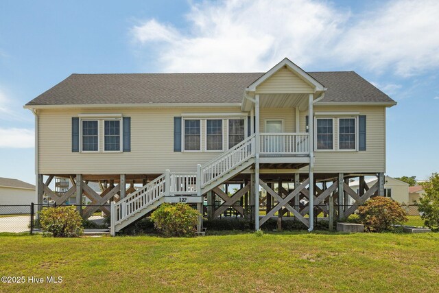 view of grassy yard with a water view, a residential view, and a boat dock