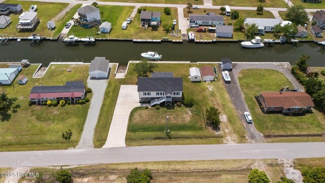 aerial overview of property's location featuring a large body of water and nearby suburban area