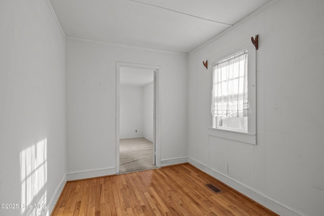 2205 Bay St, Morehead City, NC 28557 - unfurnished bedroom with light wood-type flooring, ornamental molding, baseboards, and visible vents