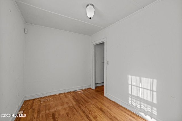 2205 Bay St, Morehead City, NC 28557 - empty room with crown molding, baseboards, and light wood finished floors