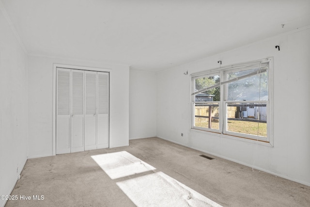 2205 Bay St, Morehead City, NC 28557 - unfurnished bedroom featuring carpet flooring, visible vents, and a closet