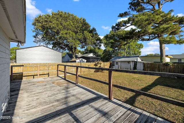 2205 Bay St, Morehead City, NC 28557 - deck featuring a yard, an outbuilding, and a fenced backyard