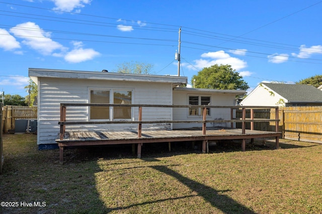 2205 Bay St, Morehead City, NC 28557 - back of house featuring a fenced backyard, a wooden deck, and a lawn