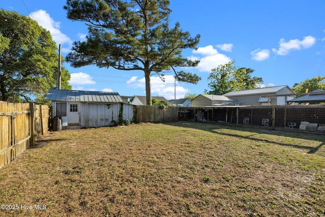 2205 Bay St, Morehead City, NC 28557 - view of yard featuring a storage shed, an outdoor structure, and a fenced backyard