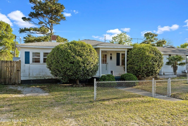 2205 Bay St, Morehead City, NC 28557 - view of front of house featuring fence private yard and a front lawn