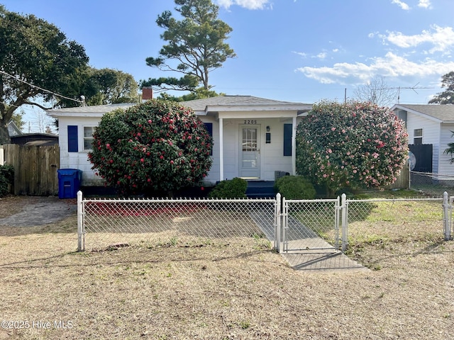 2205 Bay St, Morehead City, NC 28557 - view of front of home with a gate, a fenced front yard, and a chimney