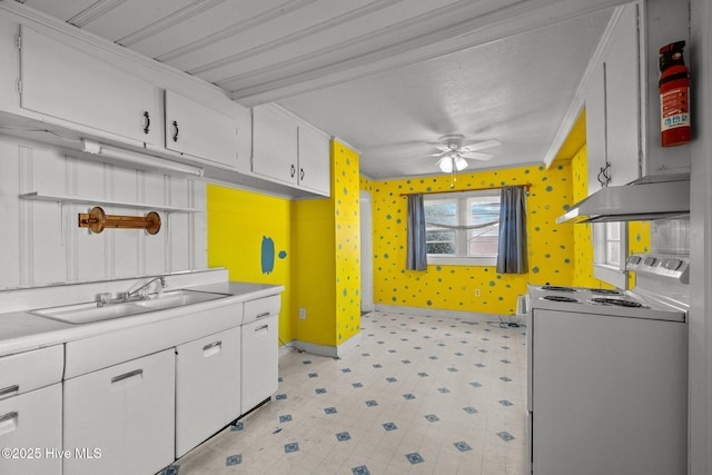 2205 Bay St, Morehead City, NC 28557 - kitchen with under cabinet range hood, white cabinetry, a sink, and white electric range