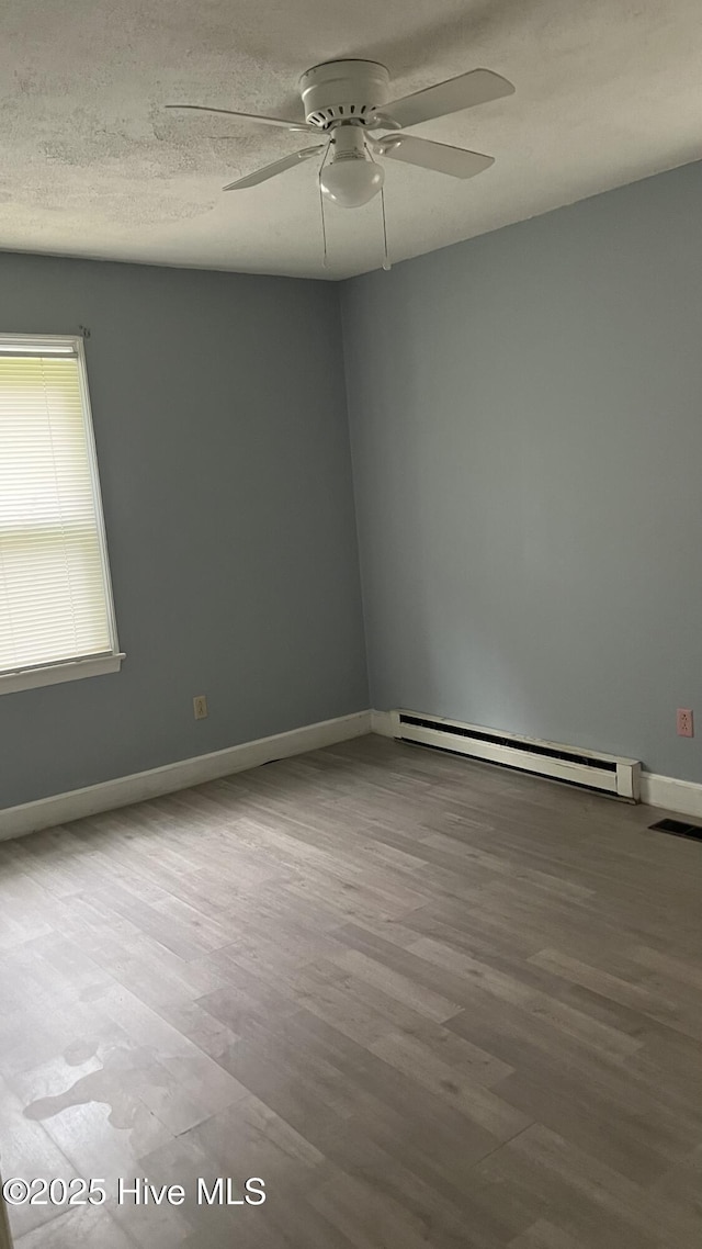 1817 Cobb Rd, Kinston, NC 28501 - empty room featuring a ceiling fan, wood finished floors, baseboard heating, and baseboards