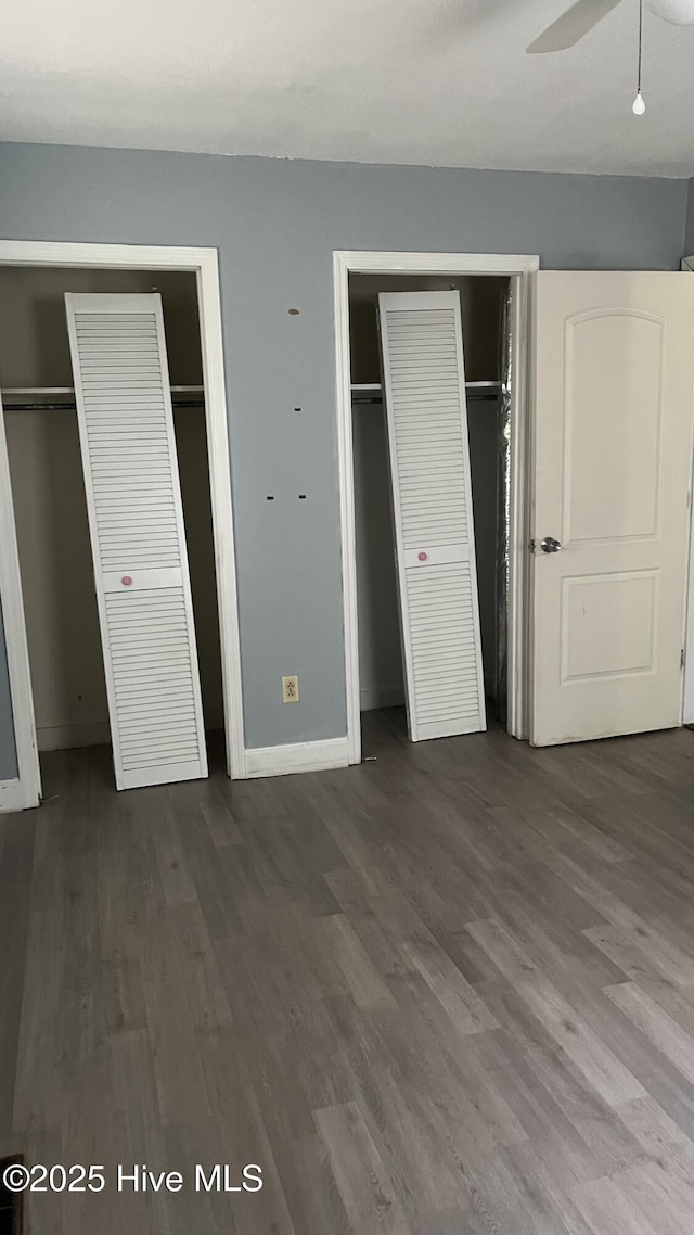1817 Cobb Rd, Kinston, NC 28501 - unfurnished bedroom featuring multiple closets, dark wood-style flooring, and baseboards