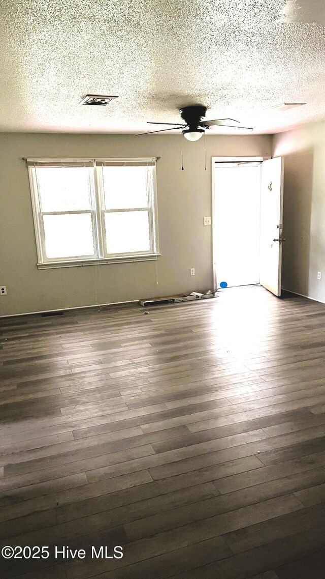 1817 Cobb Rd, Kinston, NC 28501 - unfurnished living room featuring a textured ceiling, ceiling fan, and wood finished floors