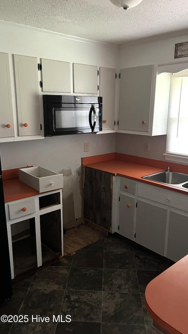 1817 Cobb Rd, Kinston, NC 28501 - kitchen featuring black microwave, a textured ceiling, and a sink