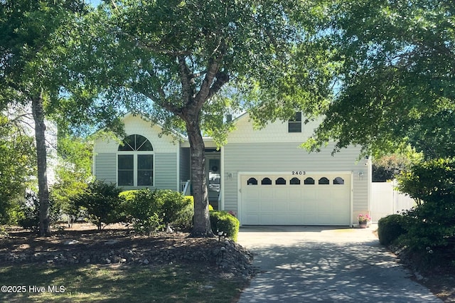 view of front of house featuring fence and driveway