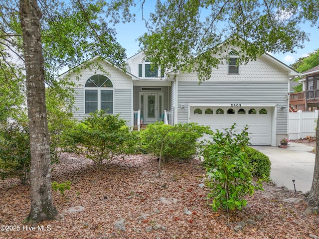 2403 W Oak Island Dr, Oak Island, NC 28465 - traditional-style house featuring concrete driveway and fence