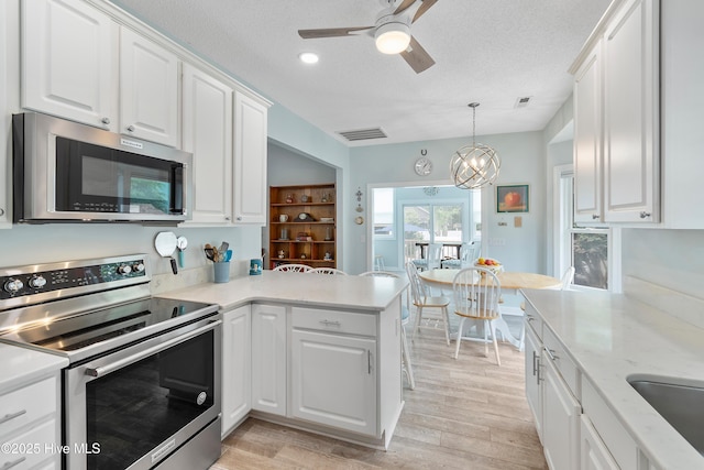 2403 W Oak Island Dr, Oak Island, NC 28465 - living room featuring a ceiling fan, high vaulted ceiling, light wood-style flooring, baseboards, and recessed lighting