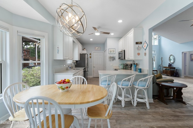 2403 W Oak Island Dr, Oak Island, NC 28465 - dining room with a ceiling fan and light wood-style flooring