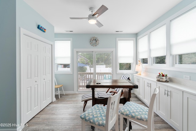 2403 W Oak Island Dr, Oak Island, NC 28465 - kitchen with a sink, stainless steel appliances, light countertops, white cabinets, and a ceiling fan