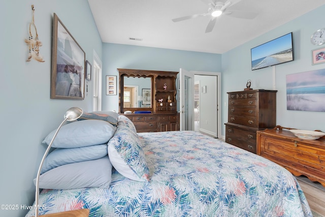 2403 W Oak Island Dr, Oak Island, NC 28465 - bedroom with multiple windows, light wood-style flooring, ceiling fan, and baseboards