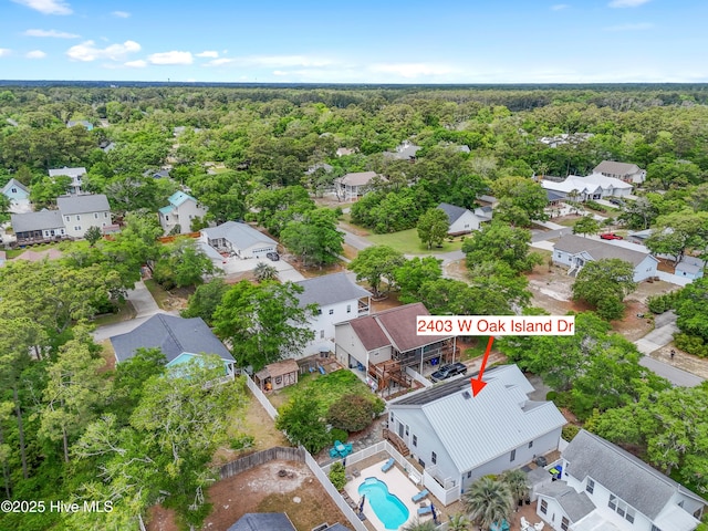 2403 W Oak Island Dr, Oak Island, NC 28465 - aerial perspective of suburban area with a pool area and a heavily wooded area