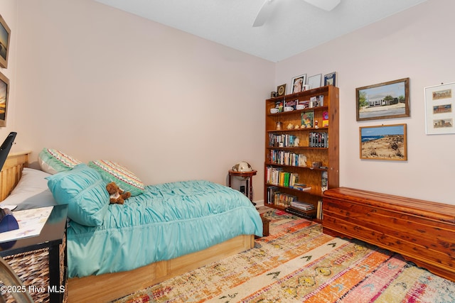 2403 W Oak Island Dr, Oak Island, NC 28465 - bedroom featuring wood finished floors, baseboards, and a ceiling fan
