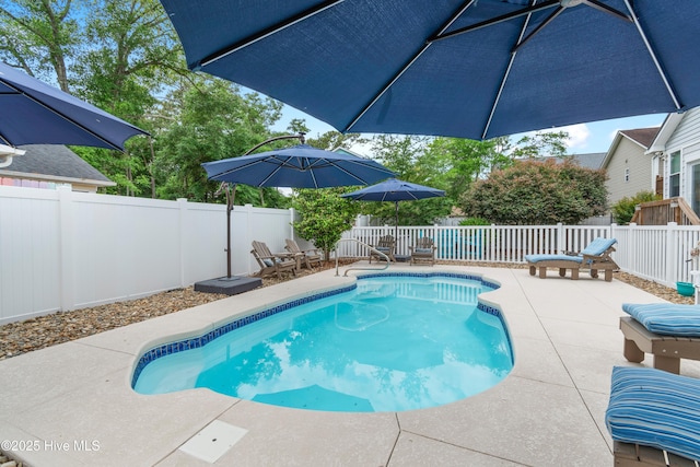 2403 W Oak Island Dr, Oak Island, NC 28465 - view of pool featuring a patio, a fenced backyard, and outdoor dining space