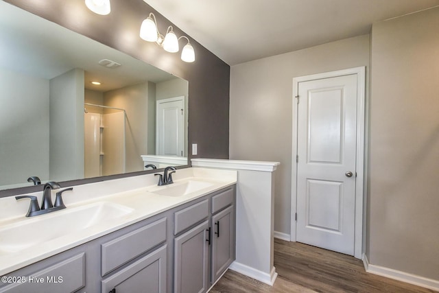 bathroom with baseboards, a sink, and wood finished floors