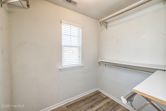 walk in closet featuring visible vents and wood finished floors