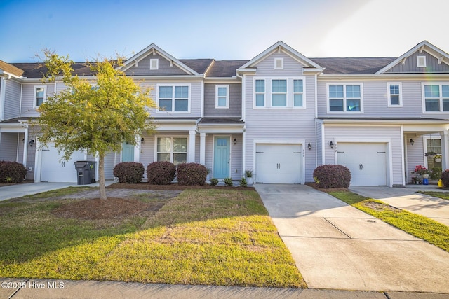 townhome / multi-family property featuring a garage, driveway, and a front lawn