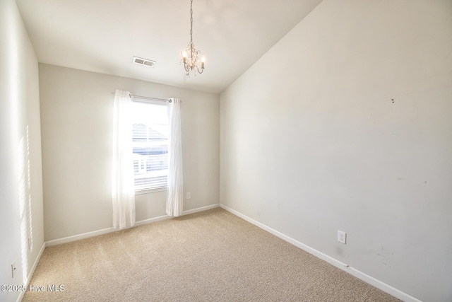 carpeted empty room featuring baseboards, a notable chandelier, and visible vents