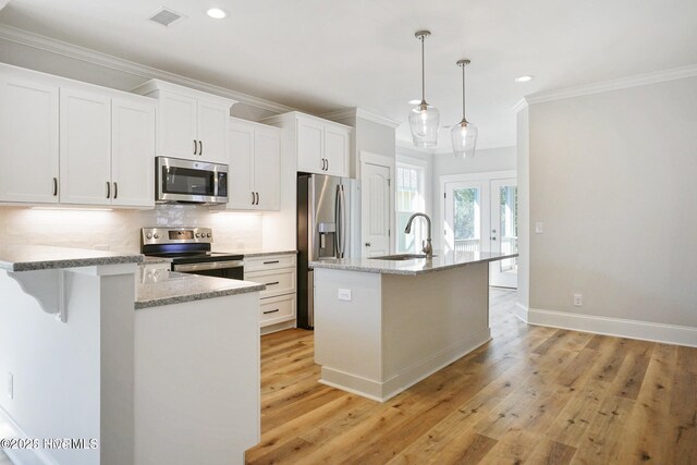 kitchen with white cabinets, recessed lighting, appliances with stainless steel finishes, and ornamental molding