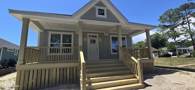 1649 Butterfly Knot Dr SW, Ocean Isle Beach, NC 28469 - view of front of house featuring board and batten siding and a porch