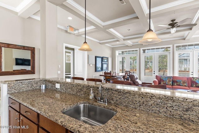 1649 Butterfly Knot Dr SW, Ocean Isle Beach, NC 28469 - kitchen with a sink, open floor plan, beamed ceiling, and coffered ceiling