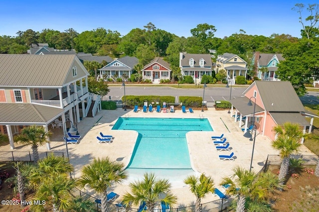 1649 Butterfly Knot Dr SW, Ocean Isle Beach, NC 28469 - community pool featuring a patio area, a residential view, and fence