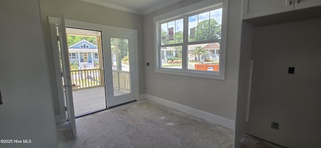 1649 Butterfly Knot Dr SW, Ocean Isle Beach, NC 28469 - doorway with ornamental molding, baseboards, and unfinished concrete flooring