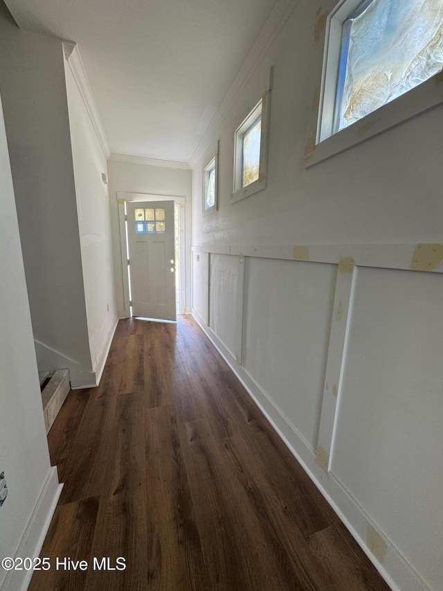 doorway to outside featuring baseboards, ornamental molding, stairs, and wood finished floors