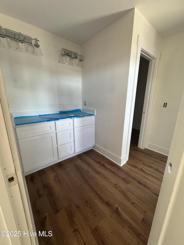 bathroom with baseboards and wood finished floors