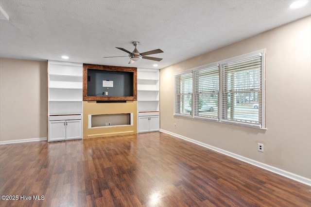unfurnished living room with baseboards, ceiling fan, and wood finished floors