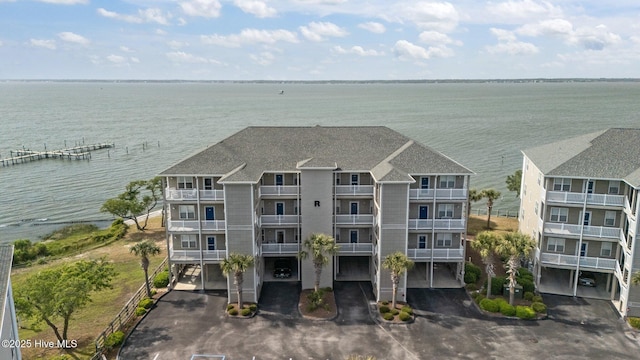 view of subject property featuring a nearby body of water and apartment complex
