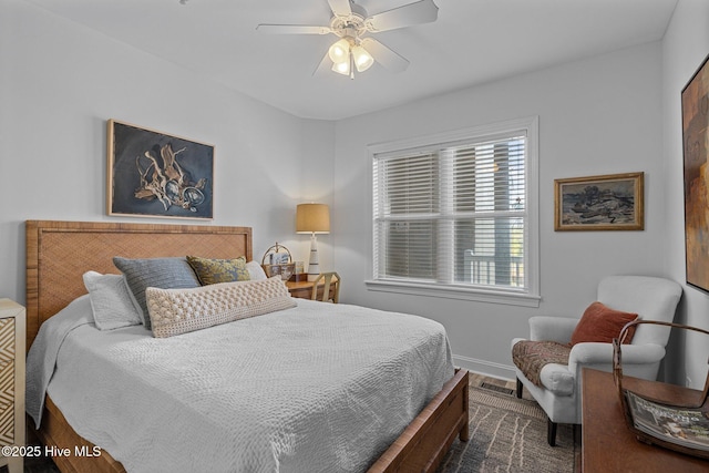bedroom with baseboards, ceiling fan, and dark wood finished floors