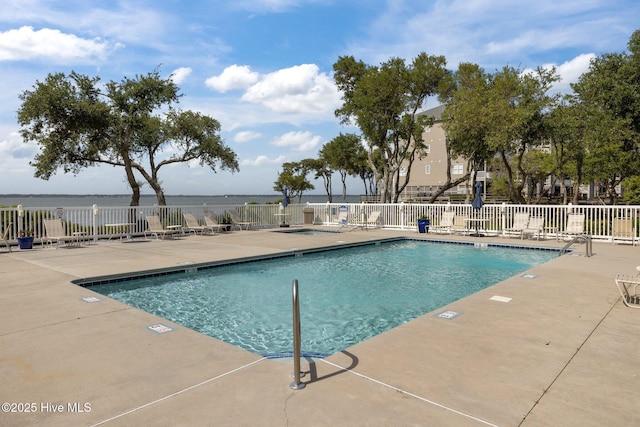 community pool with fence and a patio area