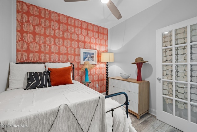 bedroom with wood finished floors, baseboards, and ceiling fan