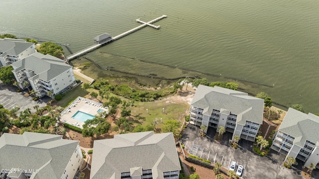 bird's eye view of a pool area and a nearby body of water