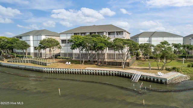 back of property featuring a water view